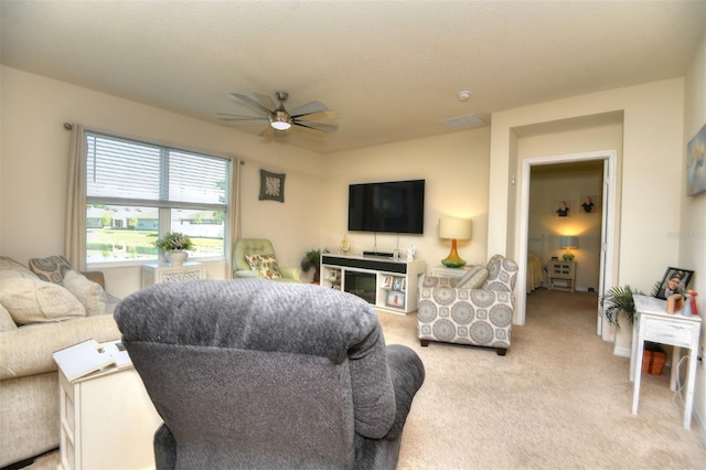 living room featuring light carpet and ceiling fan