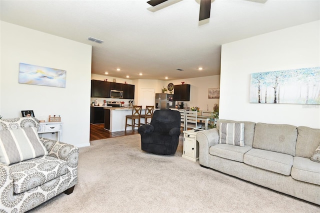 living room featuring ceiling fan and light wood-type flooring