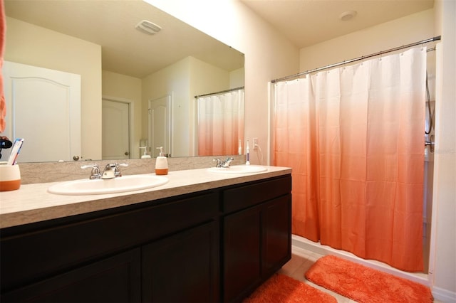 bathroom with double sink, tile flooring, and vanity with extensive cabinet space