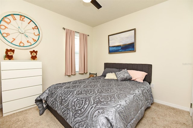 bedroom featuring light colored carpet and ceiling fan