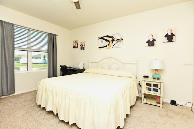 bedroom with ceiling fan and light colored carpet