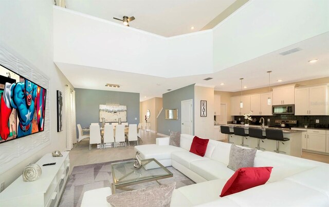 living room with a high ceiling and sink