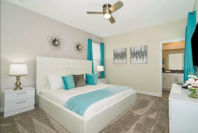 bedroom with light carpet, ensuite bathroom, ceiling fan, and sink