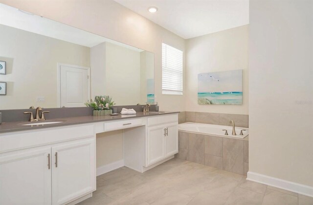 bathroom with dual vanity, tile flooring, and tiled bath