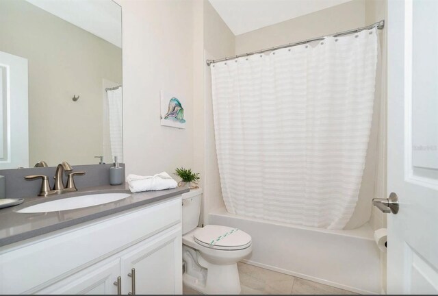 full bathroom featuring shower / bath combination with curtain, tile flooring, toilet, and vanity