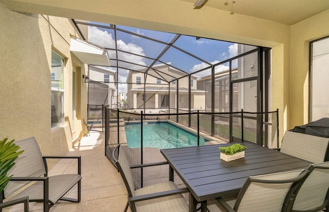 view of swimming pool featuring a patio area and a lanai