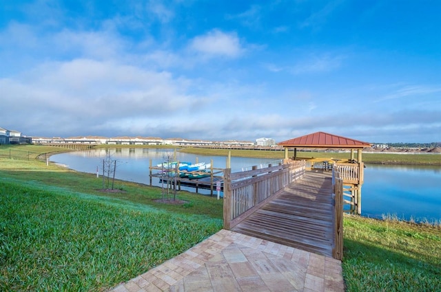 dock area featuring a lawn, a water view, and a gazebo