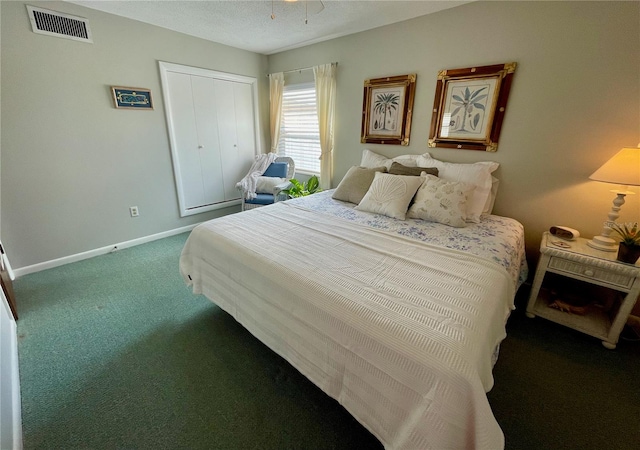 bedroom with a closet and dark colored carpet