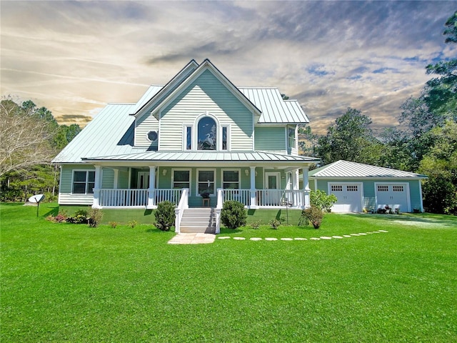 farmhouse inspired home featuring a lawn, a garage, and covered porch