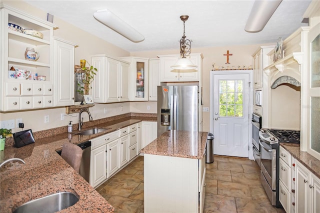 kitchen featuring appliances with stainless steel finishes, sink, light tile floors, and stone countertops