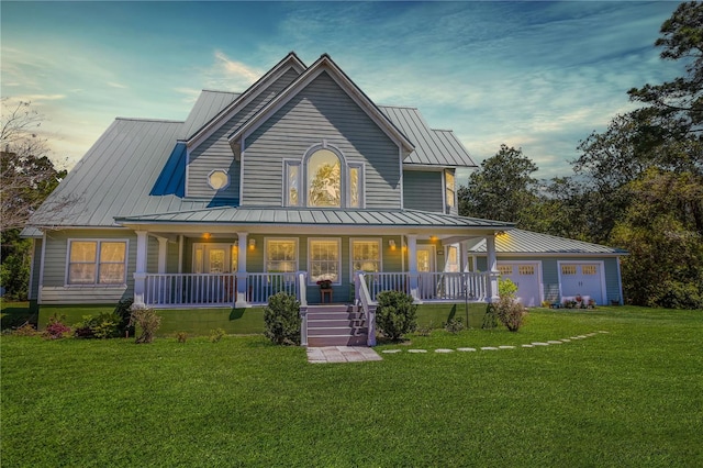 farmhouse inspired home featuring a porch and a yard