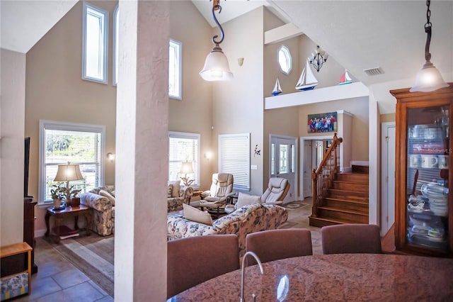 tiled living room featuring high vaulted ceiling