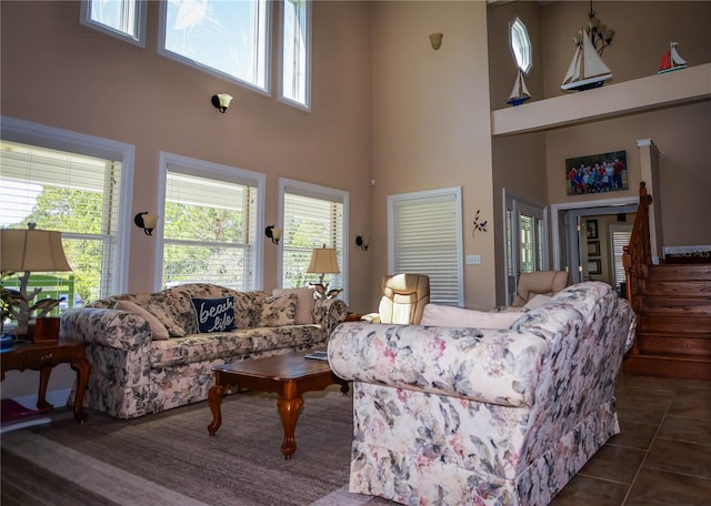 tiled living room featuring a towering ceiling