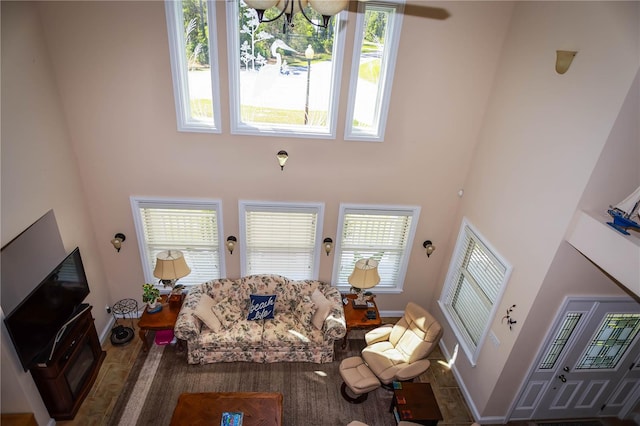 living room featuring a chandelier and a towering ceiling