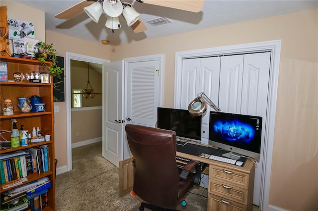 carpeted office featuring ceiling fan