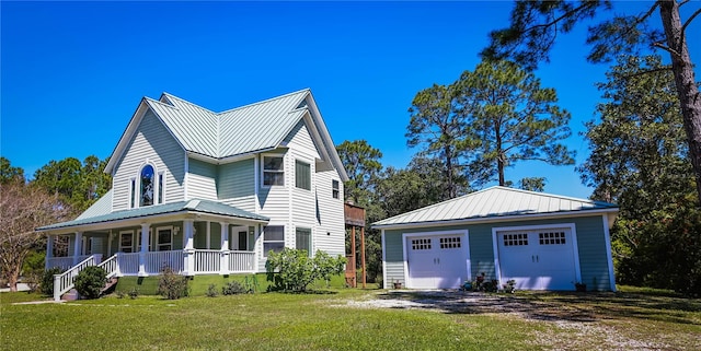 view of front of property with a garage, a porch, and a front lawn