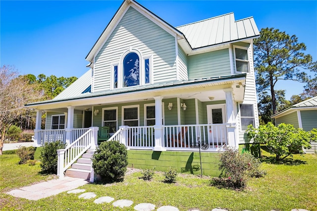 view of front of house featuring covered porch and a front lawn