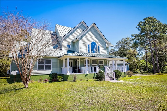 view of front facade with covered porch and a front yard