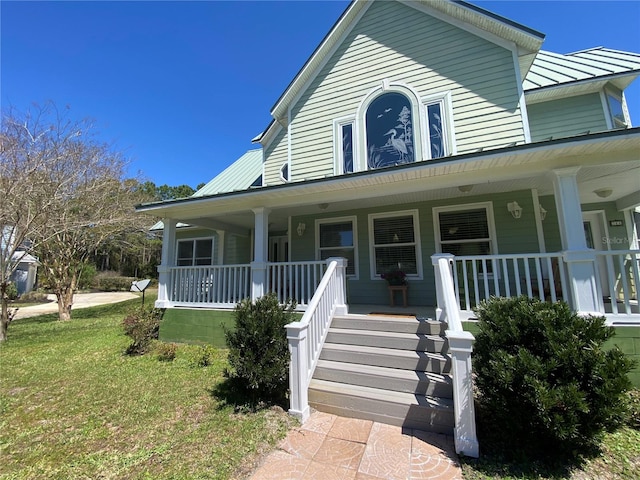 view of front of house with a front yard and a porch