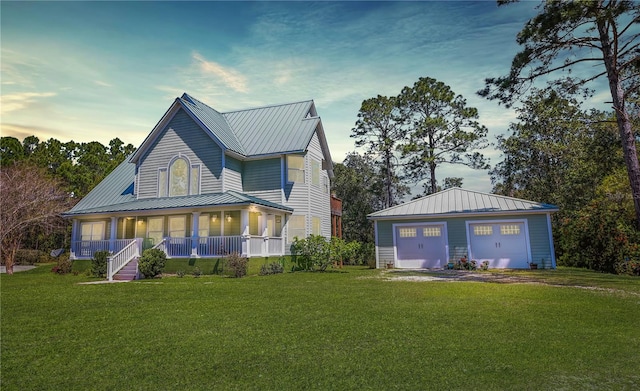 view of front of home featuring a yard, a porch, and a garage