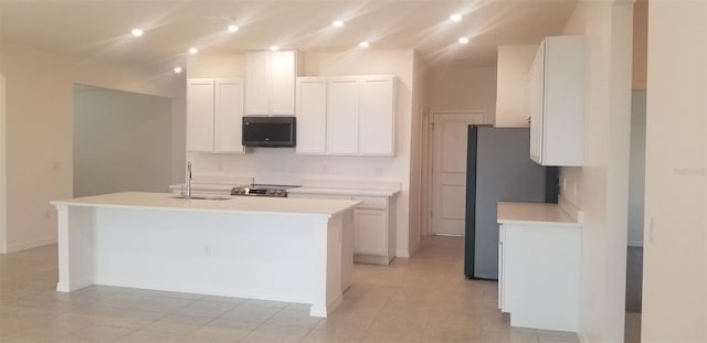 kitchen featuring sink, a center island with sink, white cabinets, and appliances with stainless steel finishes