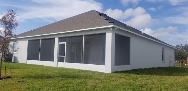 view of property exterior featuring a yard and a sunroom