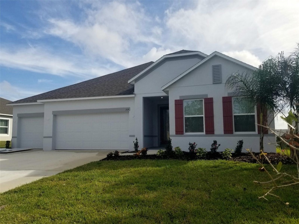 ranch-style home featuring a garage and a front lawn