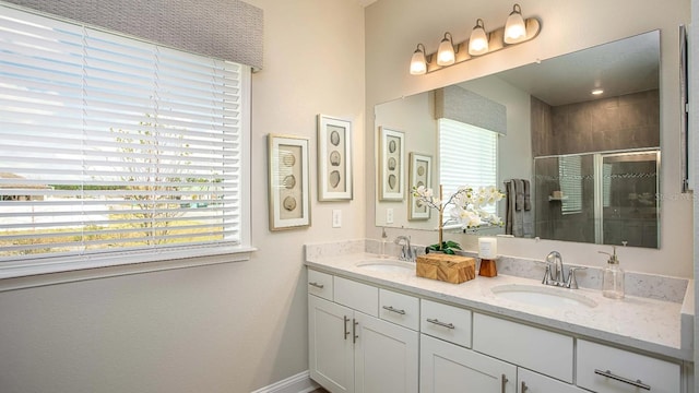 bathroom featuring vanity and an enclosed shower