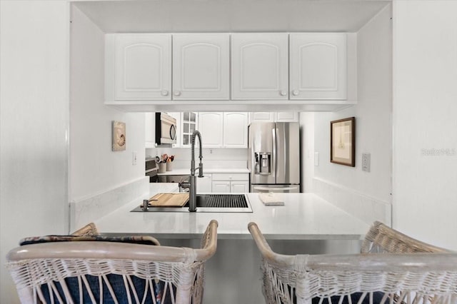 kitchen with white cabinets, stainless steel appliances, and sink