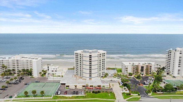 aerial view with a water view and a beach view