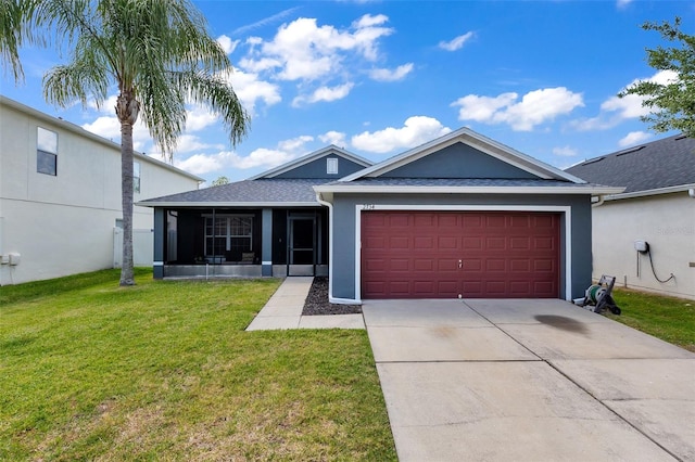 single story home featuring a garage and a front lawn