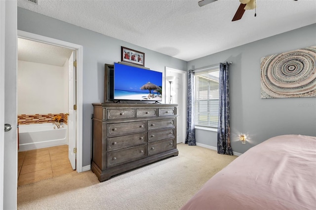 bedroom featuring ceiling fan, a textured ceiling, and light carpet