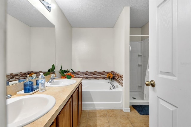 bathroom with dual sinks, a textured ceiling, plus walk in shower, tile floors, and large vanity