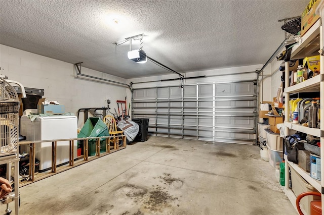 garage with washer / dryer and a garage door opener