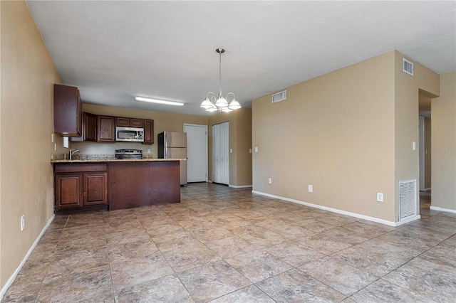 kitchen with decorative light fixtures, appliances with stainless steel finishes, a chandelier, and light tile floors