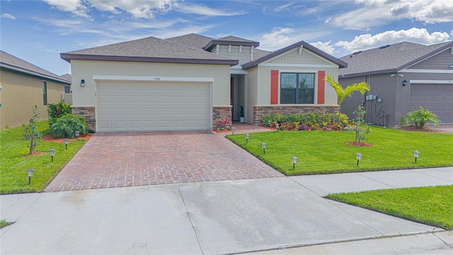 prairie-style home featuring a front yard and a garage