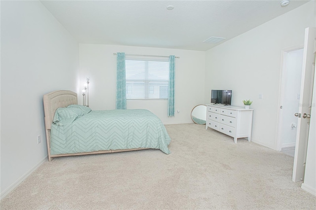 bedroom featuring light carpet