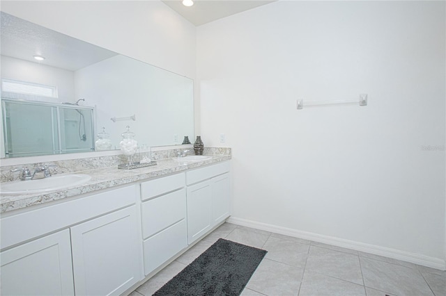 bathroom featuring tile patterned flooring, vanity, and walk in shower