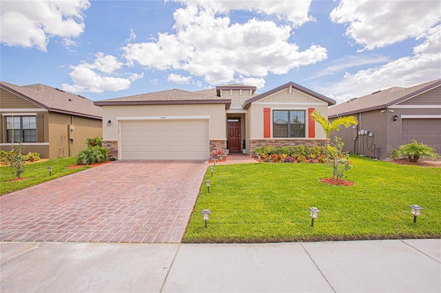 view of front of property featuring a front yard and a garage