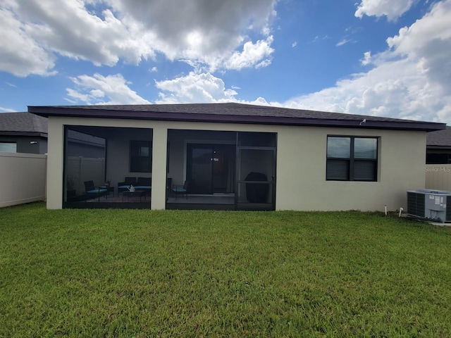 back of property featuring central AC, a sunroom, and a yard