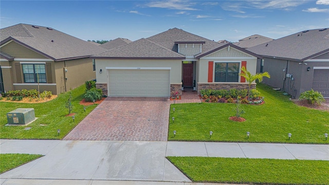 view of front of home featuring a garage and a front lawn