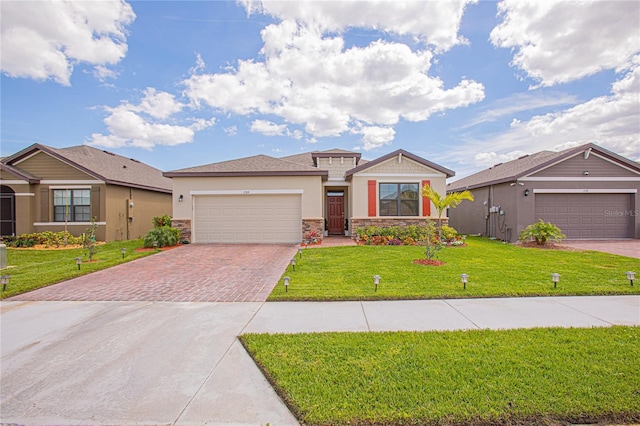 view of front of home with a garage and a front lawn