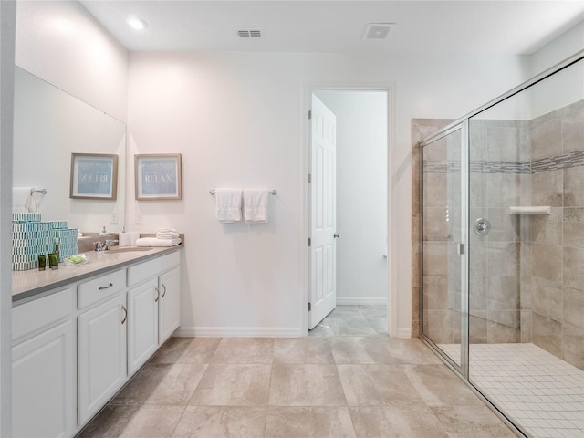 bathroom featuring tile flooring, an enclosed shower, and vanity