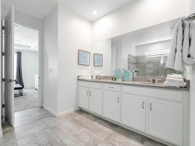 bathroom featuring tile flooring, tiled shower, and dual bowl vanity