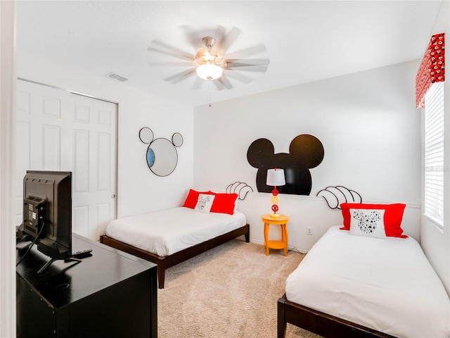 carpeted bedroom featuring ceiling fan