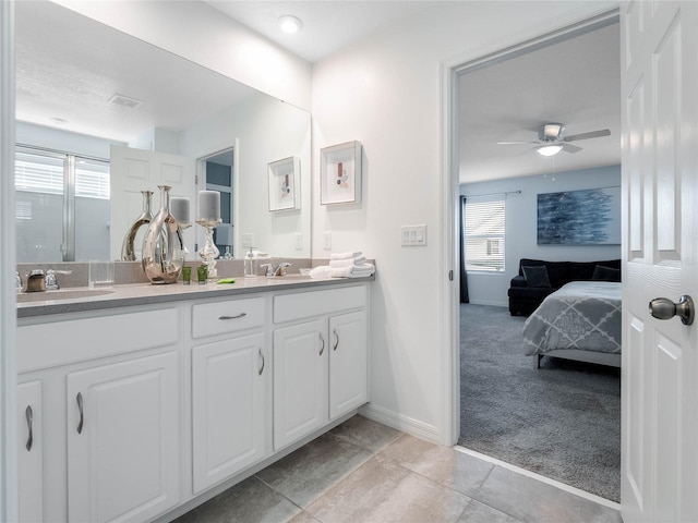 bathroom featuring oversized vanity, tile floors, dual sinks, and ceiling fan