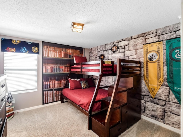 bedroom with light colored carpet and a textured ceiling