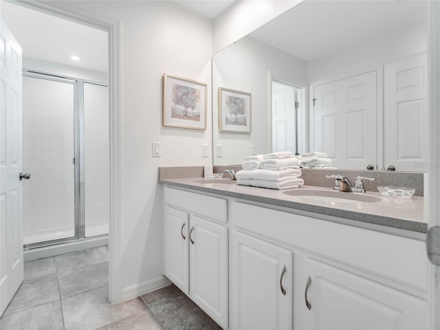 bathroom featuring an enclosed shower, tile flooring, and double vanity