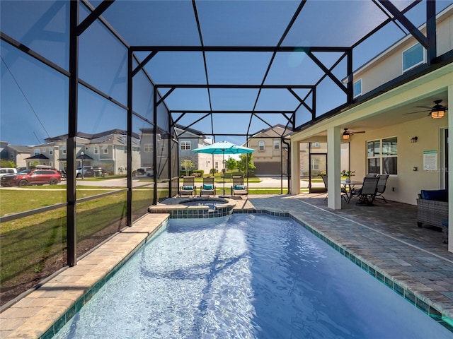 view of pool with a yard, ceiling fan, a patio area, an in ground hot tub, and a lanai