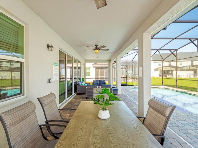 sunroom featuring a swimming pool and ceiling fan